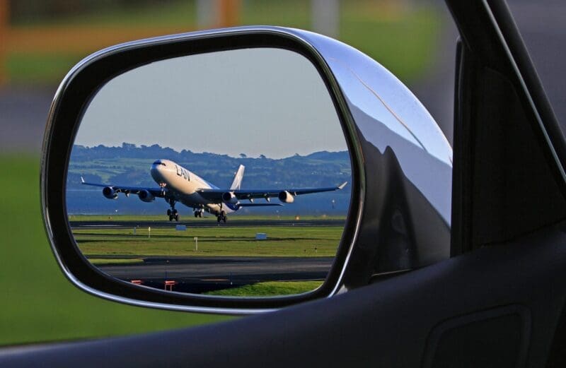 Airplane in mirror of Limousine