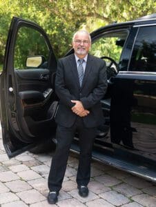 Jacksonville car service customer pickup by limo driver Artie with Black Car Service SUV